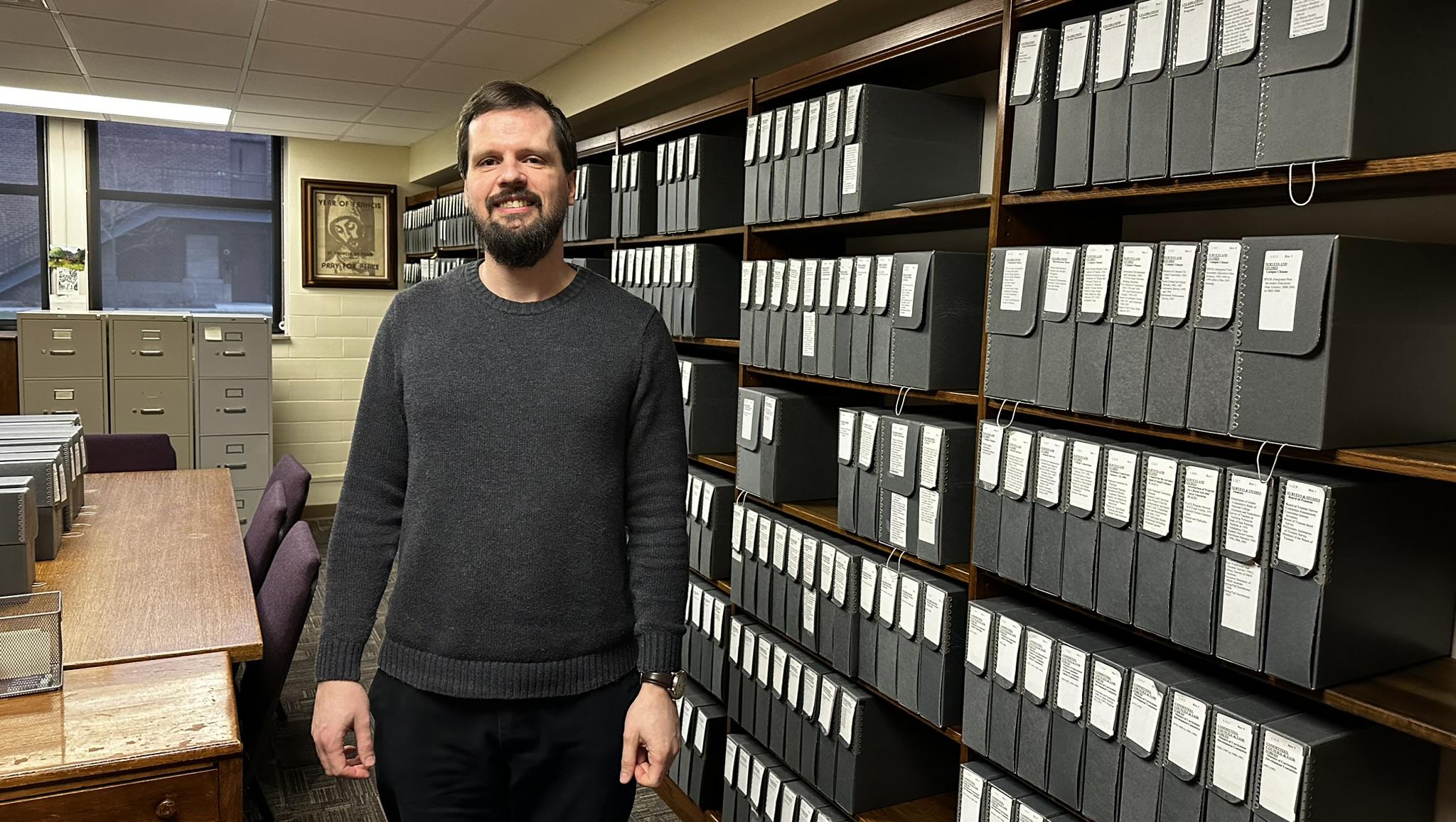 Jason Skoog in the Viterbo University archives room