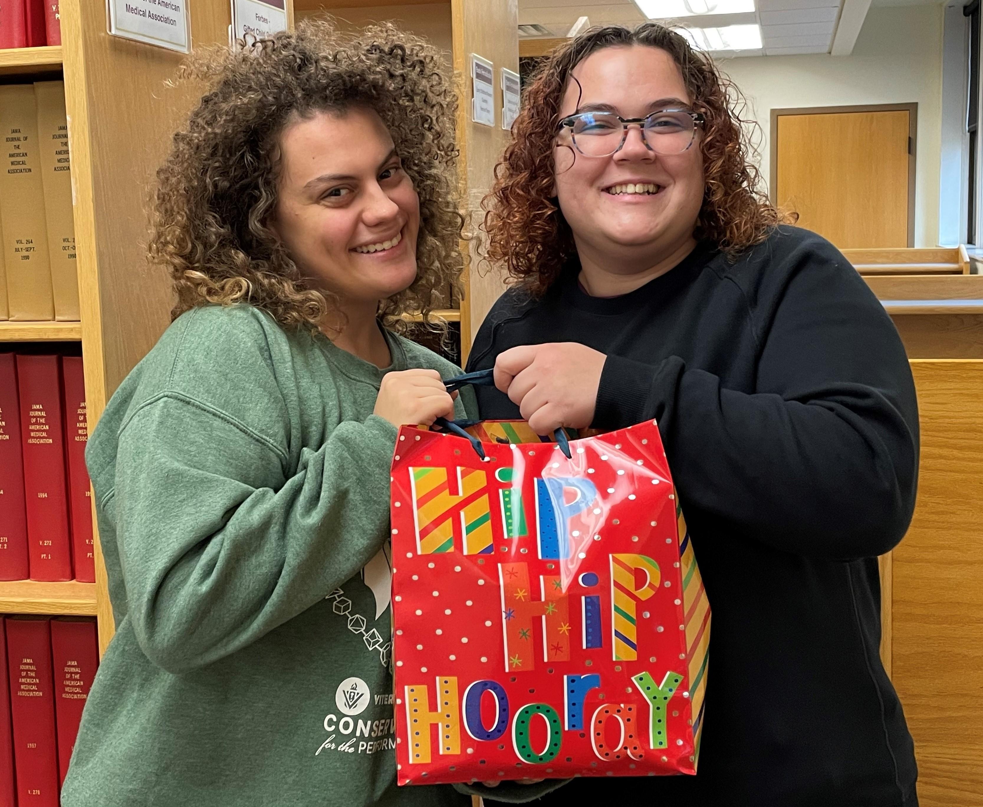 Megan Wheelock and Gabby Ramsey holding their gift bag prize