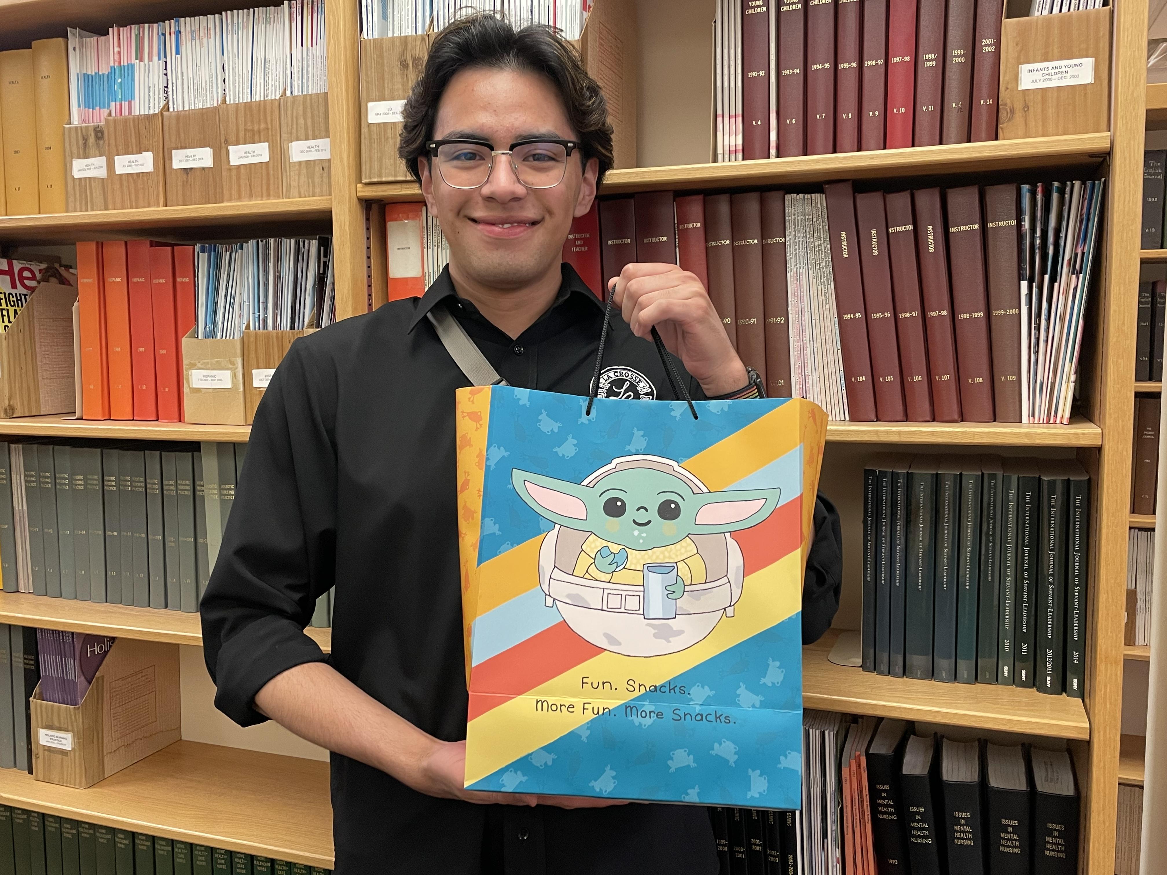 Luis Jimenez holding his gift bag of snacks and drinks