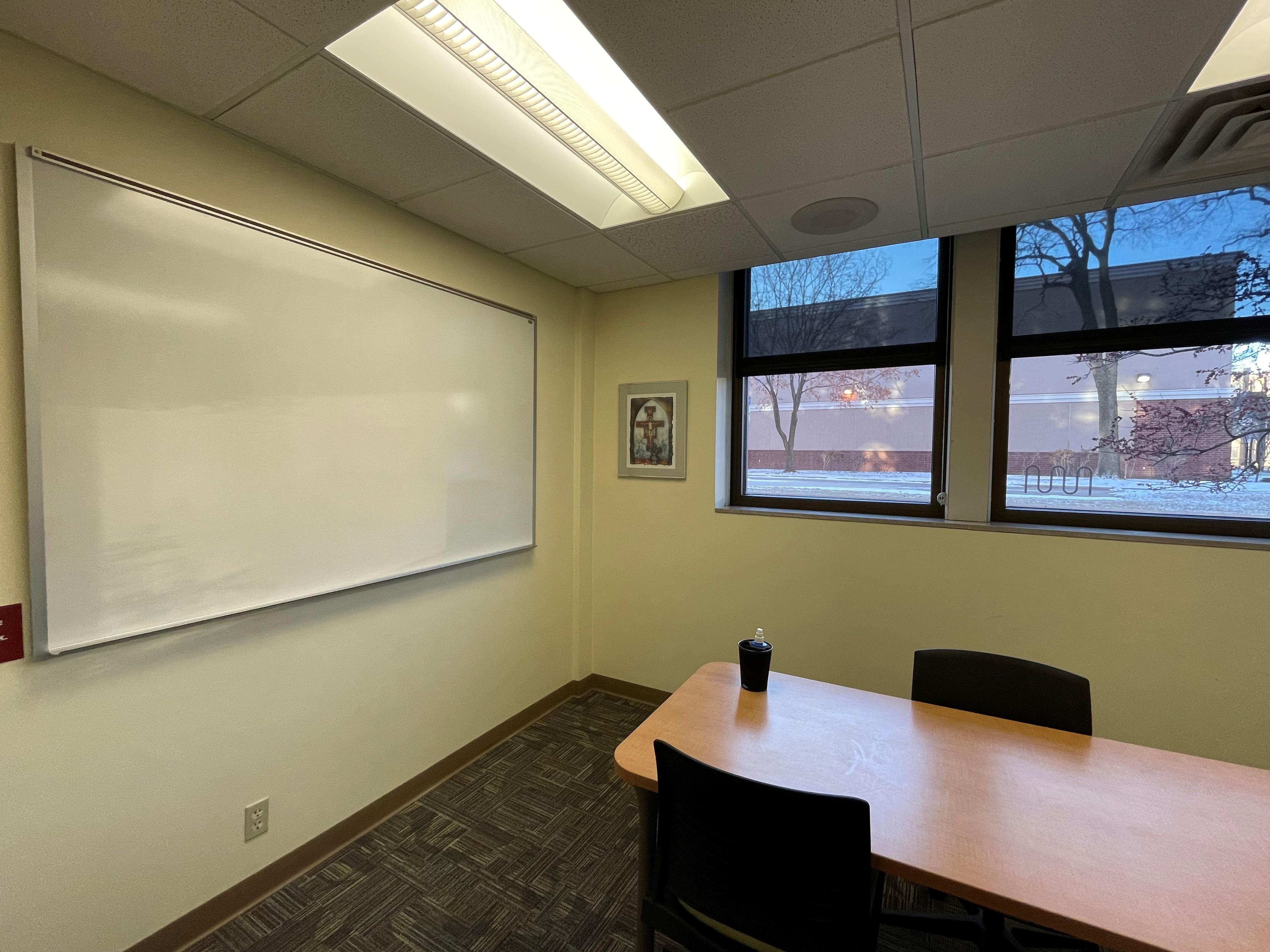 Interior photograph of LIB 126 showing whiteboard and table with two chairs