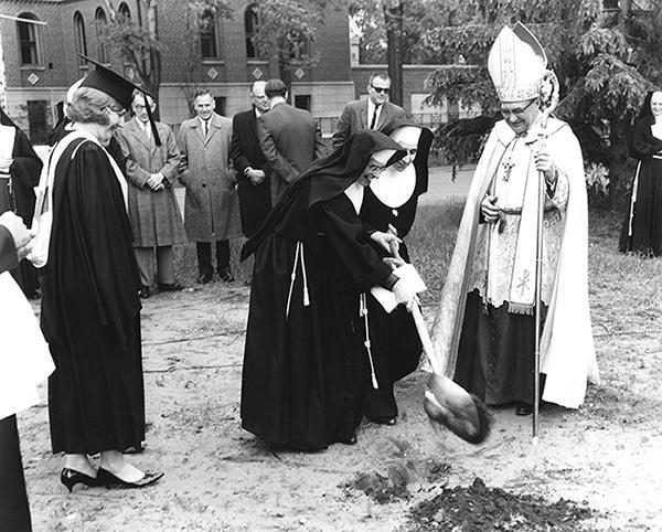 Photo of the groundbreaking of Marian Hall North (later called Bonaventure) and Cafeteria on May 28, 1965. Sister Grace McDonald (front) and Mother Ann Marie Kerper turn the first spade full of dirt, while Bishop Frederick Freking leads the proceedings.