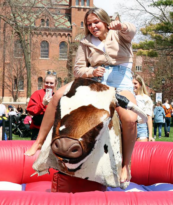 Student riding a mechanical bull