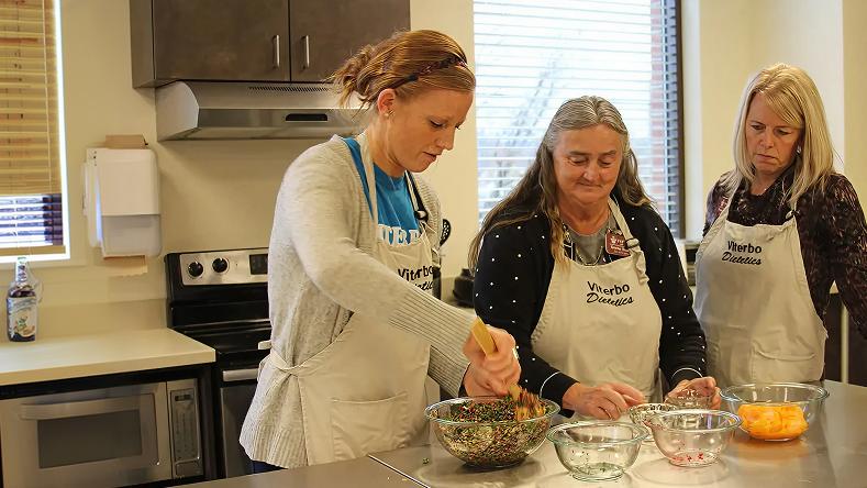 Three women observing nutrition experiment