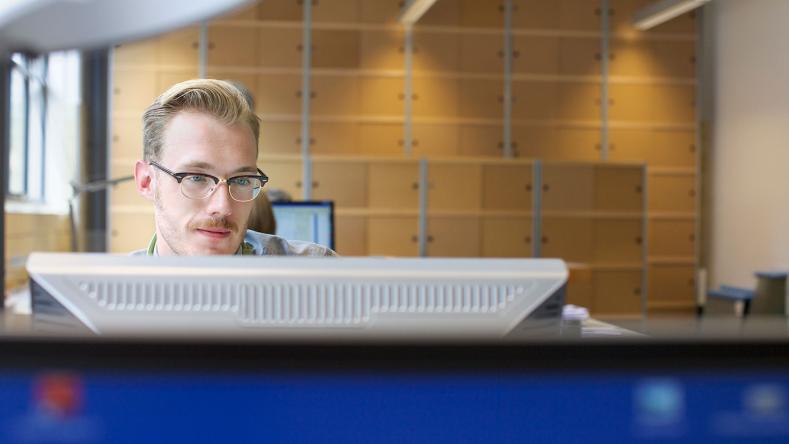 Individual looking at security screens 