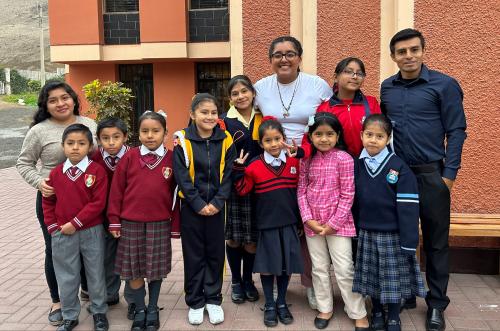 Viterbo student Maria Ruiz Martinez (center rear) is pictured with Casa Hogar residents who are part of Familia Fatima, one of eight family groupings that make up the facility.