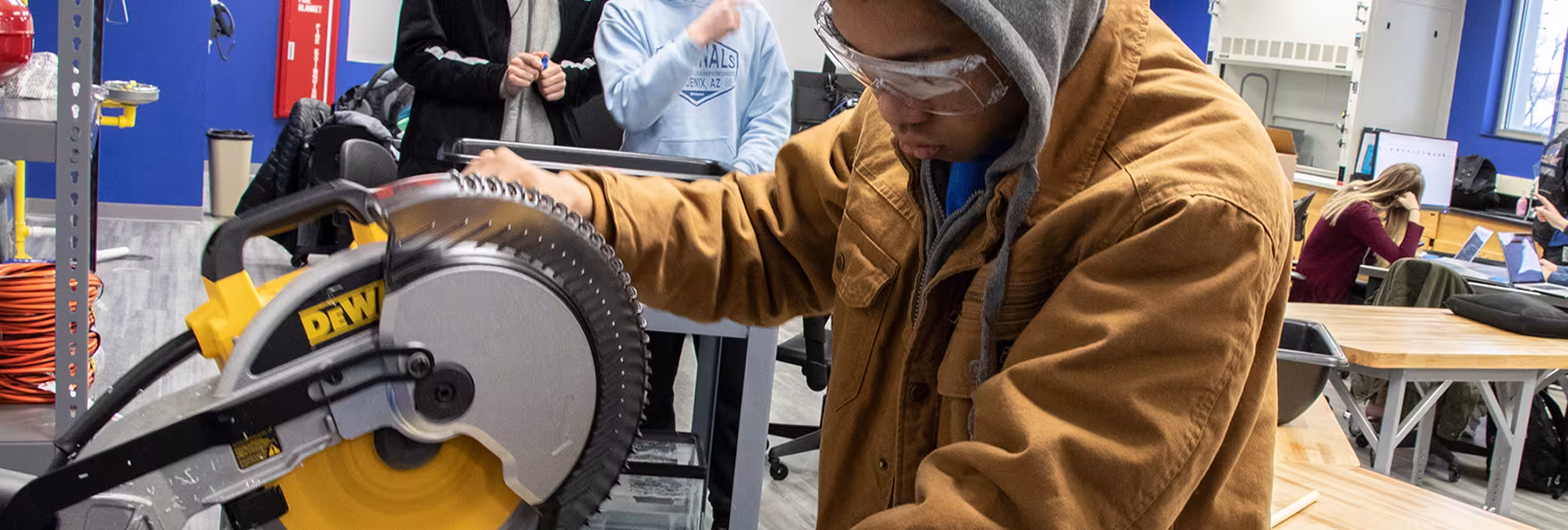 Engineering student working a saw