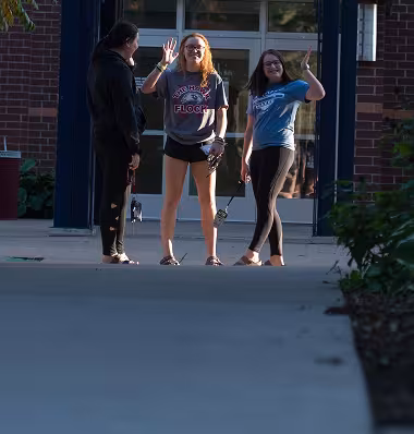 Students waving