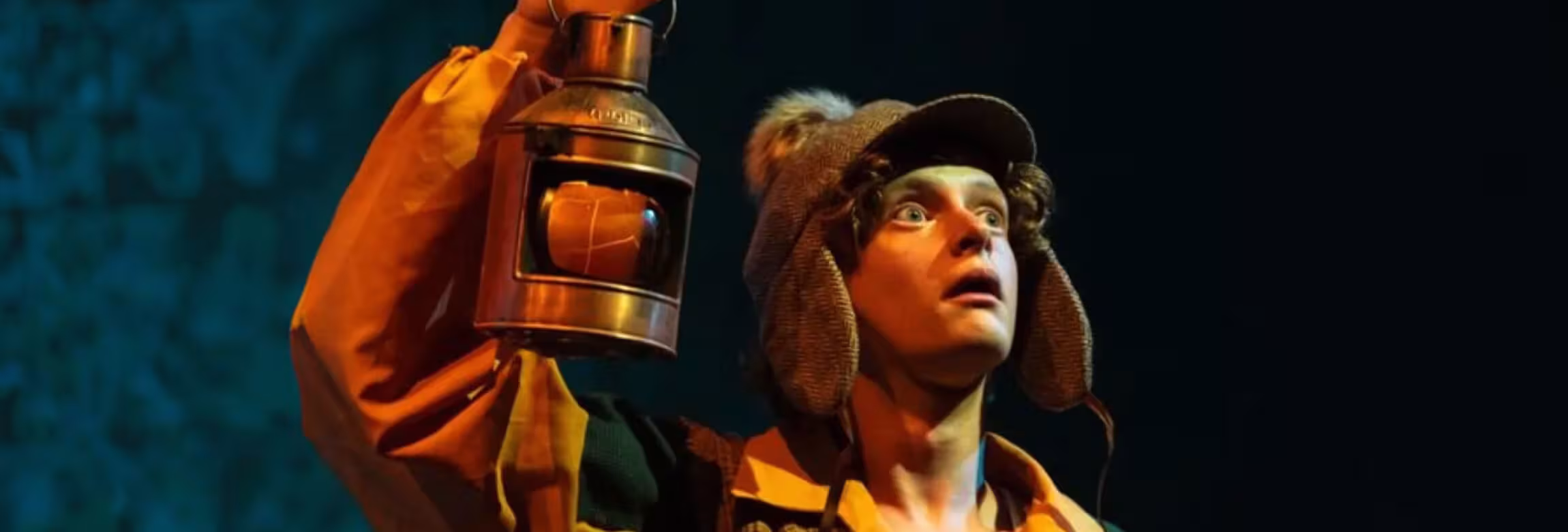 scene from production, guy with lantern looking surprised